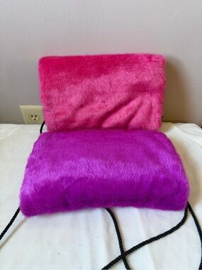 Two faux fur hand warmer muffs.